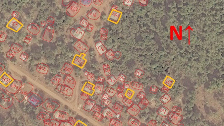 Satellite image of a village with settlements manually highlighted