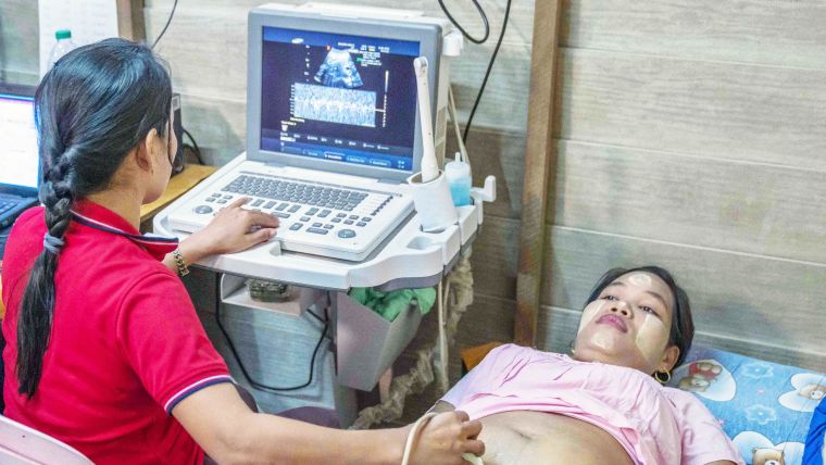 A pregnant woman undergoes an ultrasound scan