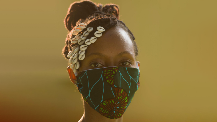 African woman wearing a face mask made of traditional fabric