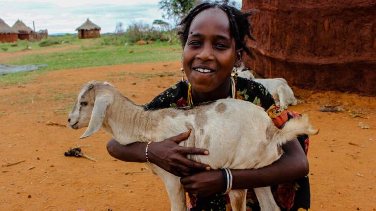 Young African girl holding a goat