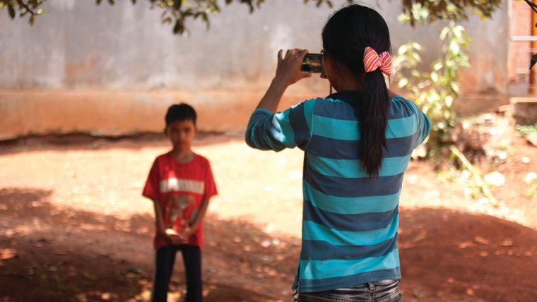 Child taking a picture of another child