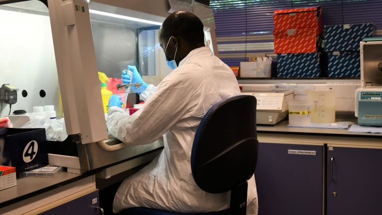 Kenyan researcher working in the lab