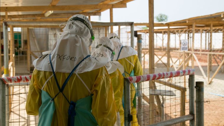 Oxford researchers wearing PPE and entering a hot zone in an Ebola facility
