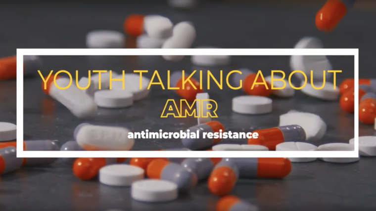 Numerous pills on a table, with the text: Youth talking against AMR - antimicrobial resistance